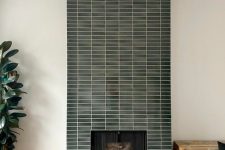 a fireplace with a green skinny tile surround is a cool addition to any living room, it looks nice and cool