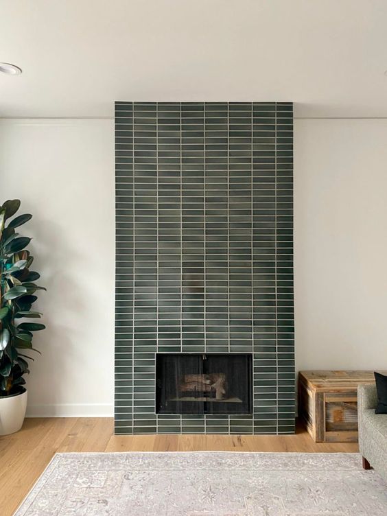 a fireplace with a green skinny tile surround is a cool addition to any living room, it looks nice and cool