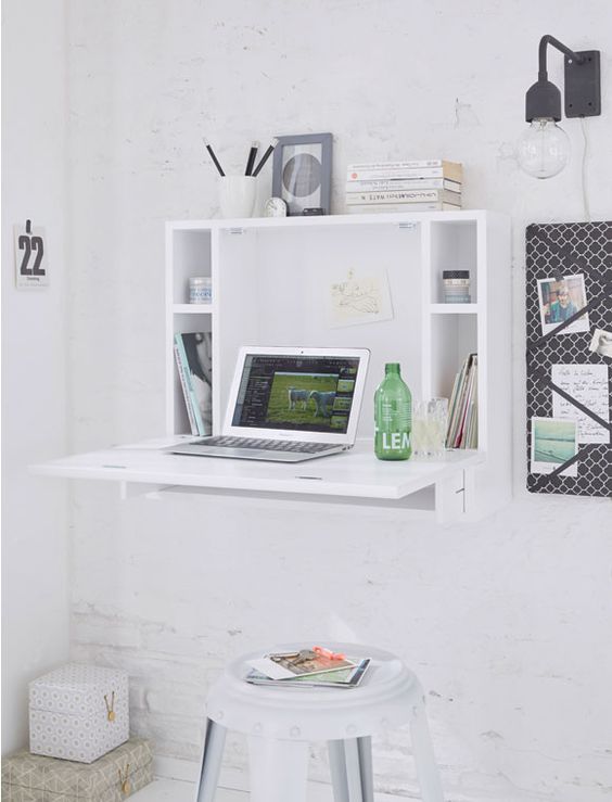 a minimalist white Murpy desk with storage compartments and a small desktop plus a white stool for an airy space