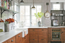 a modern meets industrial kitchen with rustic wood cabinets, white marble countertops and high tech gadgets