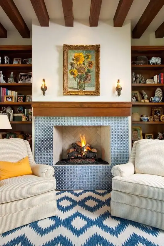 a refined fireplace clad with blue and white patterned tiles and with a rich stained wooden mantel