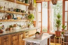 a rustic meets boho kitchen with Moroccan lanterns, wooden cabinets and a shabby chic kitchen island