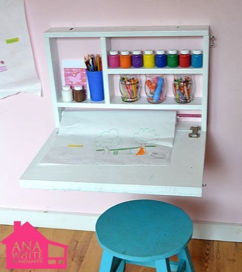 a small and minimal kid's Murphy desk done in white will become a cool yet small art center that won't take much space
