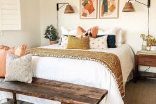 an eclectic bedroom with a bed and printed bedding, a stained bench, dark-stained nightstands, artwork and woven lamps