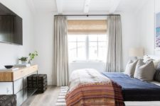 an eclectic bedroom with neutrals and various muted colors, mixed prints and mid-century modern furniture