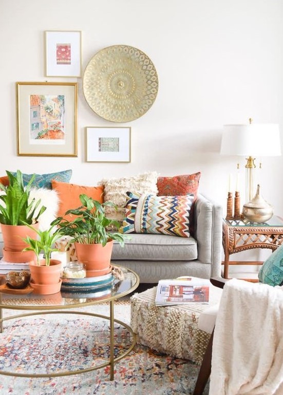 an eclectic living room with terracotta touches, folksy and boho decorations and a unique gallery wall