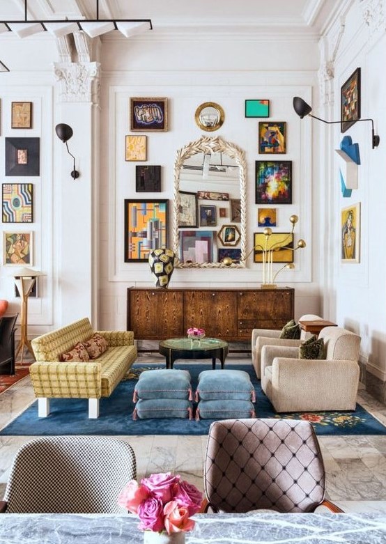 an eclectic living space with a large gallery wall, a vintage mirror, velvet furniture of various colors