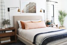 an eclectic sleeping space with an upholstered bed, wooden mid-century nightstands, vintage glam lamps and much more