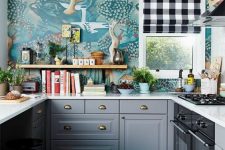 an extra bold eclectic kitchen with grey shaker cabinets, bold printed wallpaper, open shelves, greenery and a plaid curtain