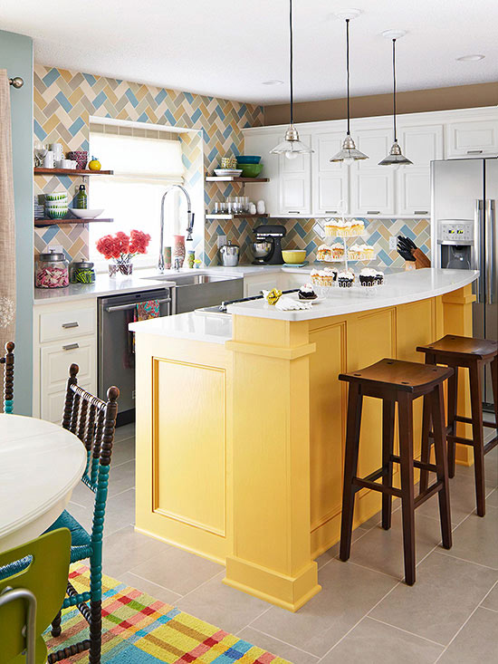 farmhouse style cabinets in white and yellow paired with a bright herringbone tile backsplash and industrial pendant lamps