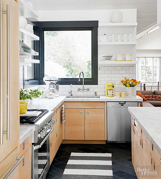 modern cabinets, white subway tiles and classic marble countertops paired with dark touches create a modern meets retro look