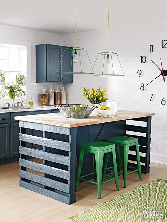 Warehouse pallets and green metal stools are paired with vintage inspired navy cabinets and butcherblock countertops