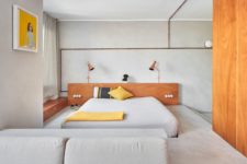 01 This minimalist apartment in Barcelona features concrete, warm-colored wood and plywood and copper touches