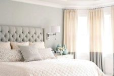 02 a soothing bedroom in light greys, with an upholstered bed, two tone curtains and an elegant bench