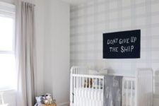 02 a welcoming and light-filled nursery with a light shaded plaid statement wall and a fun white polka dot rug
