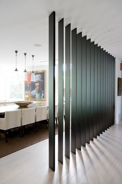 dark wooden slats can be a nice room divider as they let light in and look contemporary and chic