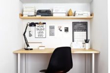 03 a mini home office nook in white, with a closed storage space and a sleek desk plus a black lamp and chair