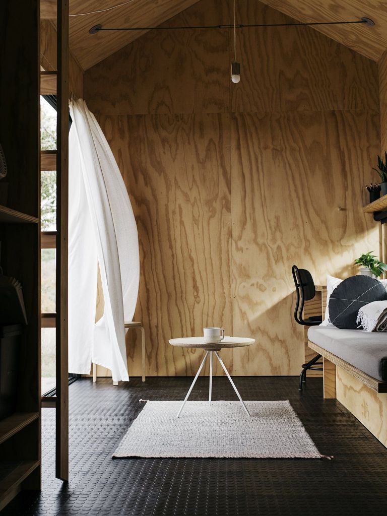Inside the cabin is done with light-colroed plywood, a matching ceiling and rubber floor tiles in black