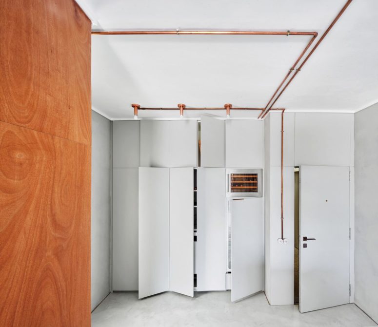 The storage is done sleek, with off-white panels and elegant piping with bulbs