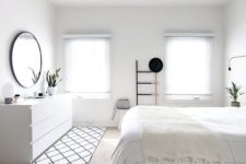 04 a pure white bedroom with a Nordic feel, a whiet sleek sideboard and shades on the windows