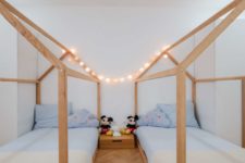 a stylish kids room with house-shaped beds