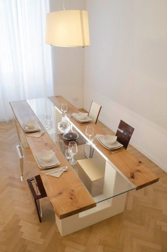 a catchy dining table of wood and glass on white geometric legs takes most of the space