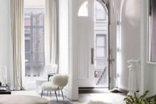 05 a neutral Parisian living room in white and beige, with high ceilings and large windows is classics