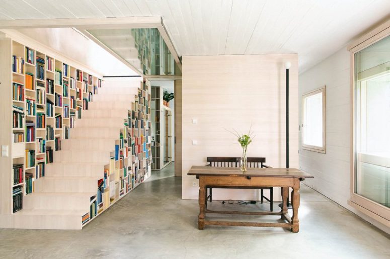 The staircase is also a bookcase, which makes the space more functional and the storage space isn't necessary