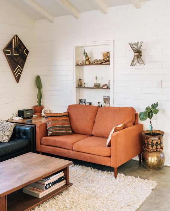 A lovely rust colored loveseat for a mid century modern living room and to add a touch of color