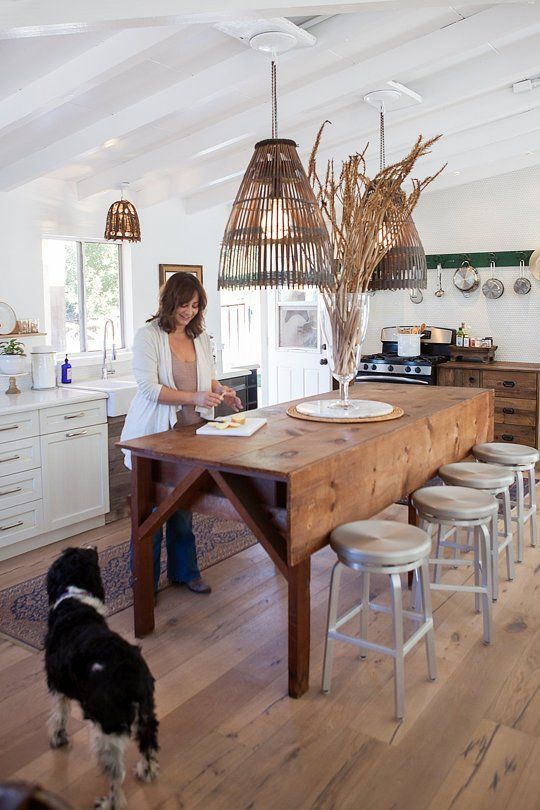 a rustic wooden drop leaf dining table, wooden lampshades that match and metal stools