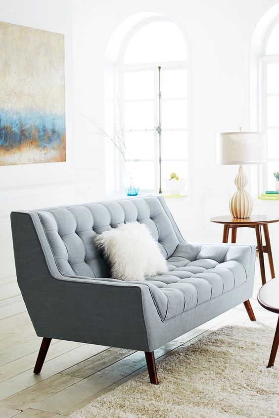 a lovely powder blue loveseat with a fluffy pillow will easily match a mid-century modern interior