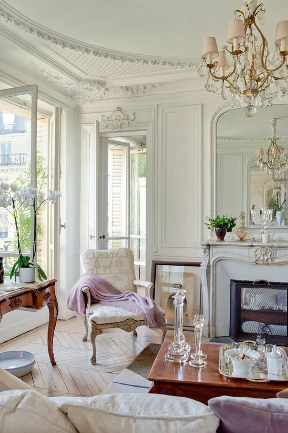 a super elegant living room with a Parisian feel and hardwood parquet floors of a neutral warm shade