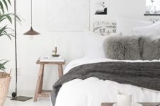 08 a neutral Scandinavian bedroom with grey accent touches and dark stained wooden furniture