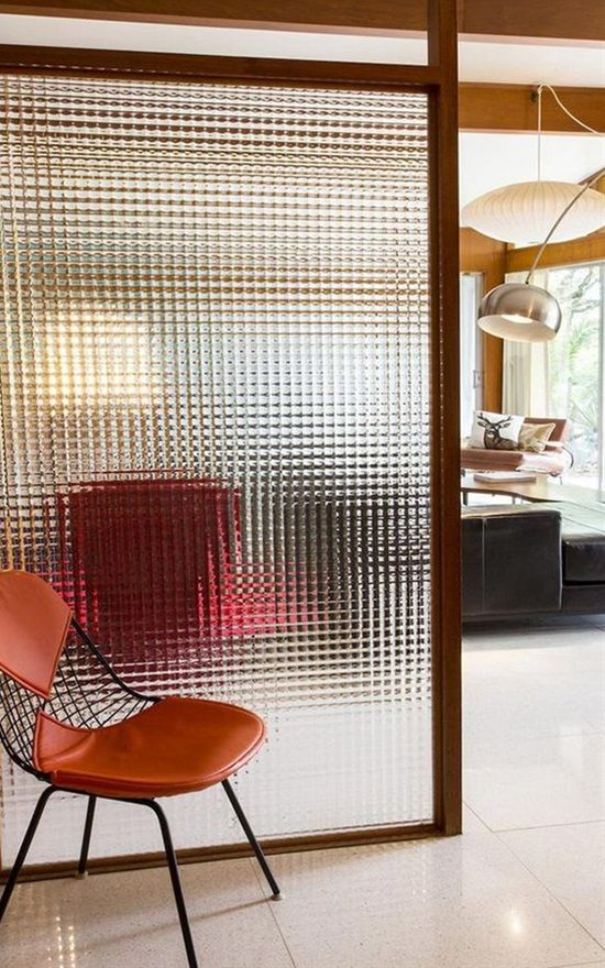 a glass screen is a neutral and not too bulky space divider for a small home