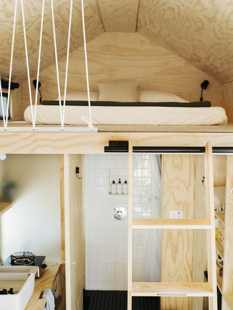 The sleeping area is upstairs and can be accessed via a wooden ladder that slides into place