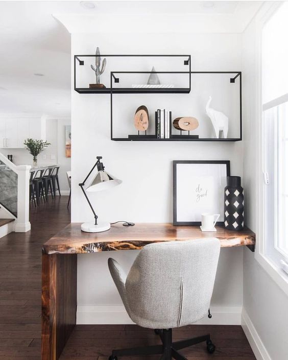 a small wall-mounted live edge wooden desk placed in an awkward corner is a genius idea with an edgy touch
