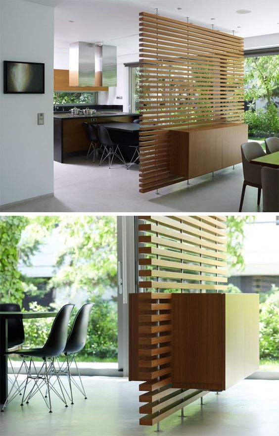 a contemporary slatted wood room divider with a cabinet integrated for storage is sheer enough for a small space
