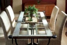 14 a vintage-inspired dining table featuring a vintage door, forged legs and a glass tabletop