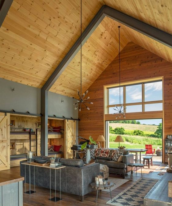 a contemporary and sleek barndominium space with a supporting metal construction and wood all around