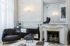 17 sophisticated molding on the walls, ceiling and fireplace make the contemporary black and white furniture more balanced