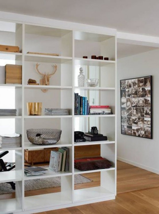 a large open shelving unit from ceiling to floor is a cool idea to separate spaces with functionality