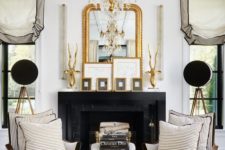 19 a refined gold and crystal chandelier and a gold framed mirror that matches for a chic touch