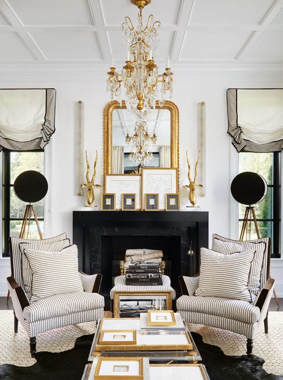 a refined gold and crystal chandelier and a gold framed mirror that matches for a chic touch