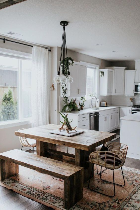 a simple wooden dining table with a minimalist design and a matching bench make the space modern yet rustic