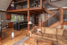 20 a cool rustic barndominium with much stained wood, light brown leather and traditional furniture