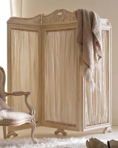 a vintage wooden screen with neutral fabric will make a chic statement in your home