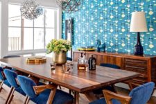 21 a rich stained wooden dining table and matching rich wood and bright blue dining chairs that look bold