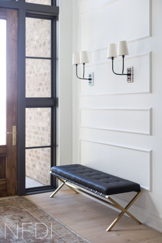 black and white sconces match the black bench and make the hallway chic and bold