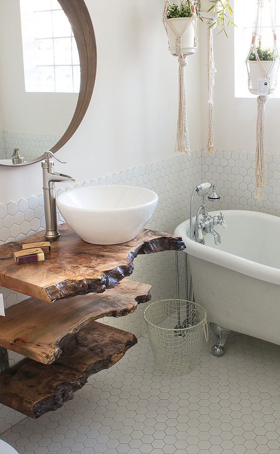 A live edge vanity made of three separate shelves makes a statement in the neutral space and adds color and texture