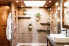 22 a warm-colored spa-like shower space done in neutrals and with a rain shower and lights for relaxation